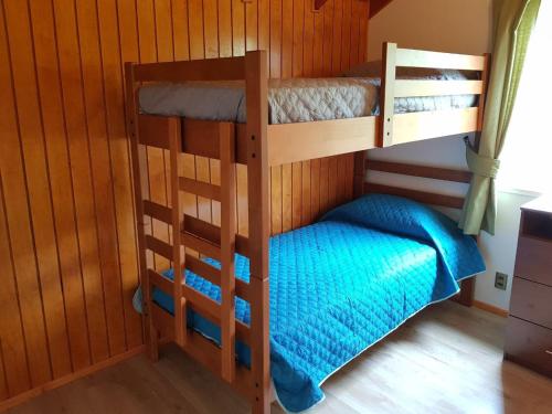two bunk beds in a room with a small bed at Cabañas Agua Viva in Puerto Montt