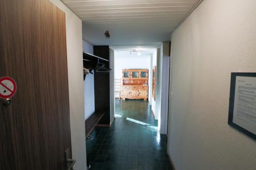 a hallway with a hallway leading to a room at Haus Pramalinis - Mosbacher in Davos