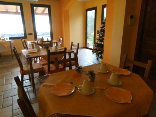 a dining room with tables and chairs and a christmas tree at Aurora dell'Etna in Zafferana Etnea