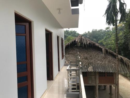 a building with a ladder next to a building with at VuLinh Family -Homestay in Yên Bình