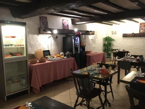 a restaurant with two tables with pink table cloth at Le Relais Des Vieilles Postes in Les Avenières