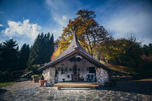 a small house with a bench in front of it at Hotel Tannenmühle in Grafenhausen