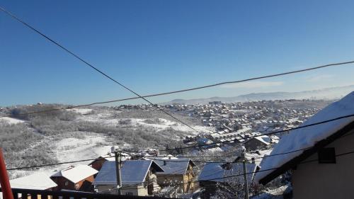 a view of a town with snow on a hill at Rooms Adrijana in Banja Luka
