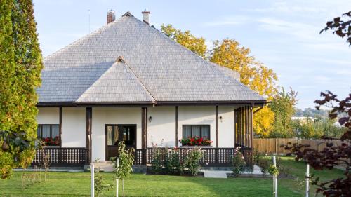 a house with a gambrel roof at Pensiunea Tara Fagilor in Suceava