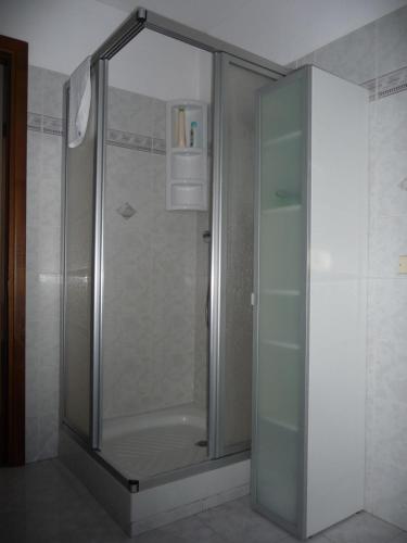 a shower with a glass door in a bathroom at Maison Borbey in Aosta