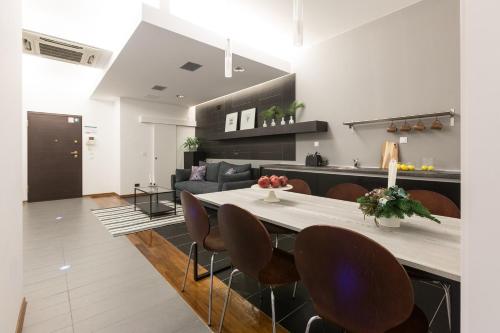a kitchen and living room with a table and chairs at Apartments City Wellness Center in Zagreb