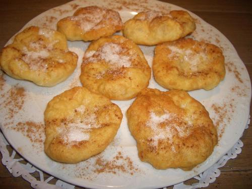 a plate of biscuits with powdered sugar on it at Familia in Vathi, Ithaka