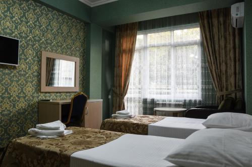 Postel nebo postele na pokoji v ubytování Antika Hotel