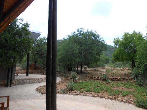 a view of a garden from a window at Morokolo Safari Lodge Self-catering in Pilanesberg