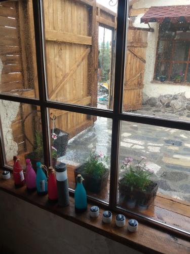 a window with vases sitting on a window sill at Lavash Hotel in Sevan