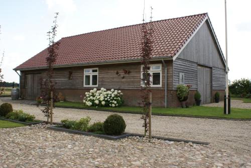 a small house in front of a building at Bed and Breakfast Gasteren in Gasteren