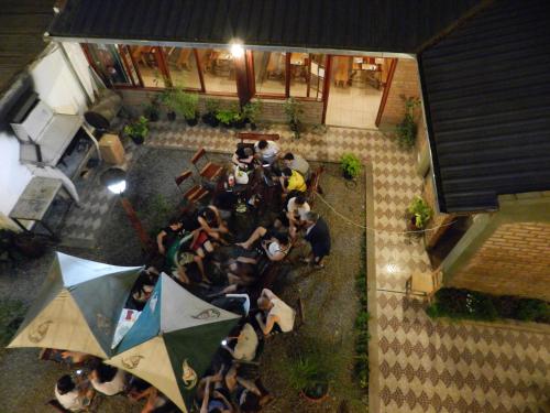 a group of people sitting at a table with an umbrella at Hotel Buenos Aires in Salta