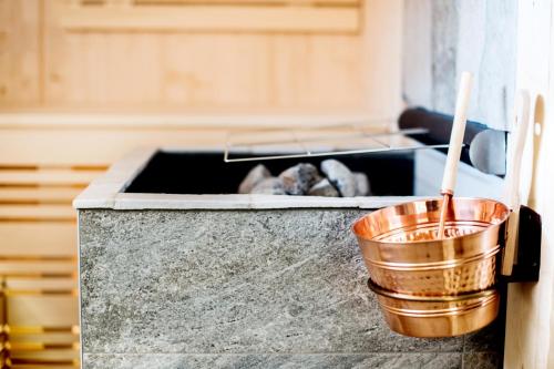 a metal bucket sitting on top of a stove at Chalet Stern in Vipiteno