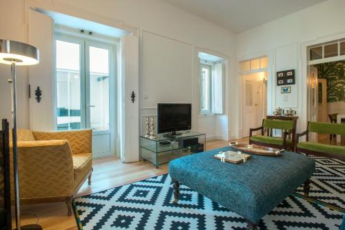 a living room with a couch and a table at Portas De São Bento Apartments in Lisbon