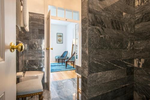 a bathroom with a stone wall at Portas De São Bento Apartments in Lisbon