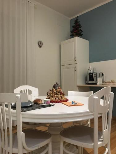 a kitchen with a table with chairs and a christmas tree at Arco dolce Arco in Benevento