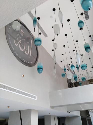 a group of blue and white chandeliers hanging from a ceiling at Bram Hotel in Jeddah