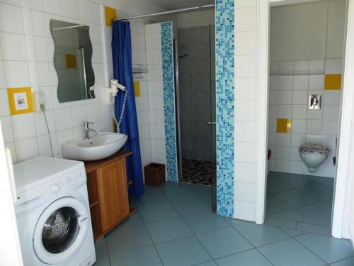 a bathroom with a washing machine and a sink at Fasslhütte in Murau
