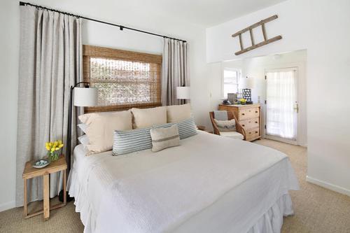 a white bedroom with a large white bed with pillows at An Inn to Remember in Sonoma