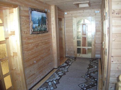 a hallway with wood paneled walls and a door at Karpatskyi Gomin in Vorokhta