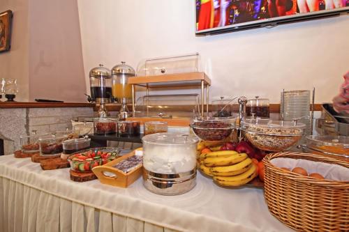 a table with fruit and other food items on it at Arion Hotel in Delfoi