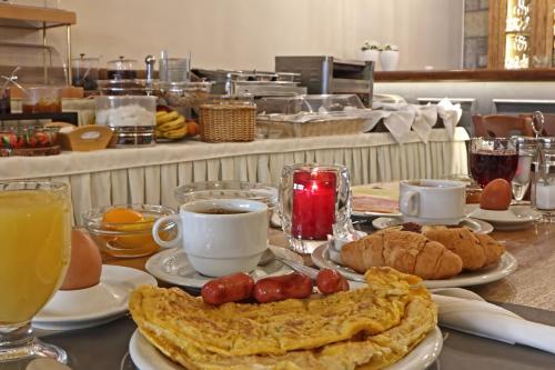 a breakfast table with an omelet and cups of coffee at Arion Hotel in Delfoi