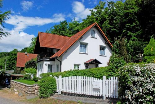 a white house with a white picket fence at Ferienappartement Lisa in Ostseebad Sellin