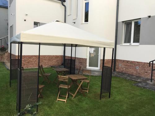 a white tent with chairs and tables under it at Apartmány Kukučín in Košice