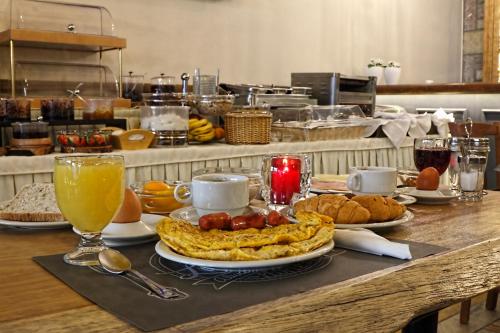 a breakfast table with food and drinks on a counter at Arion Hotel in Delfoi