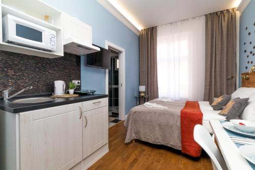 a hotel room with a bed with a sink and a microwave at Residence Vaclavska in Prague
