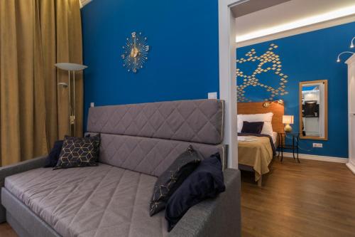 a living room with a couch and a blue wall at Residence Vaclavska in Prague