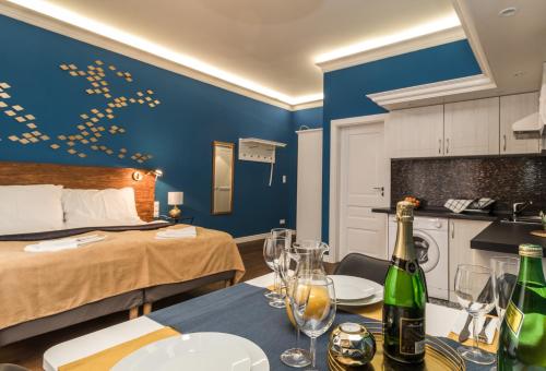 a hotel room with a bed and a table with wine glasses at Residence Vaclavska in Prague