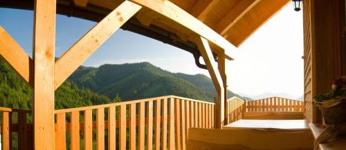 a porch of a cabin with a view of mountains at Biobauernhof Lacken in Strohmarkt