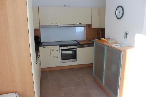 a small kitchen with a stove and a microwave at Haus Walter in Filzmoos