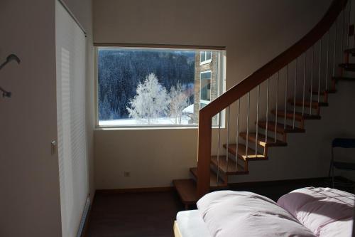 a room with a staircase and a large window at Haus Walter in Filzmoos