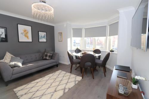 a living room with a couch and a table and chairs at Dunfermline - Luxury Two Bedroom Apartment - TP in Dunfermline