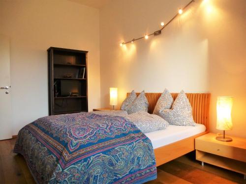a bedroom with a bed with pillows on it at Lovely, central apartment with balcony in Innsbruck