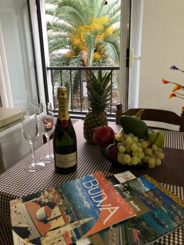 a table with a bottle of wine and a book at Apartment Viva in Budva