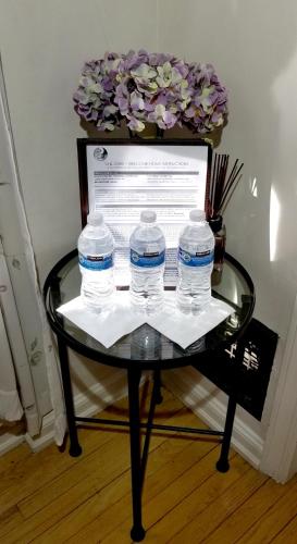 a table with three water bottles on top of it at The Patrician Hollywood Universal in Pasadena