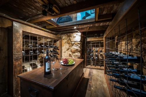 a wine cellar with a table with a bottle of wine at Grand Mercure Basildene Manor in Margaret River Town
