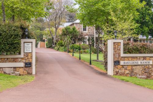 a walkway in front of a house with a sign that reads bennington mansion at Grand Mercure Basildene Manor in Margaret River Town