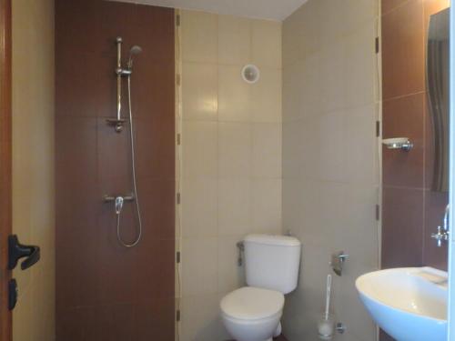 a bathroom with a shower with a toilet and a sink at Family Hotel Golden Lion in Primorsko