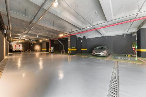 a parking garage with a car parked in it at Anyang Boutique Hotel AMA in Anyang
