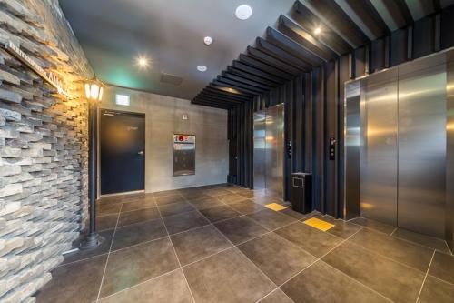 a hallway of a building with a brick wall at Anyang Boutique Hotel AMA in Anyang