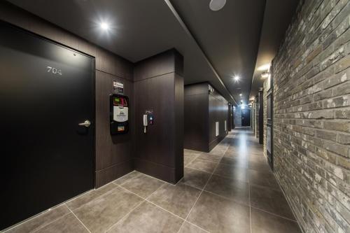 a hallway with a row of stalls in a building at Anyang Boutique Hotel AMA in Anyang