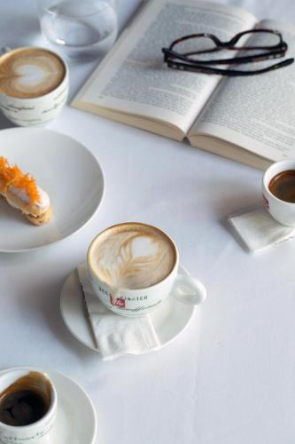 a table with three cups of coffee and a book at Intercontinental Shenzhen Dameisha Resort by IHG in Shenzhen