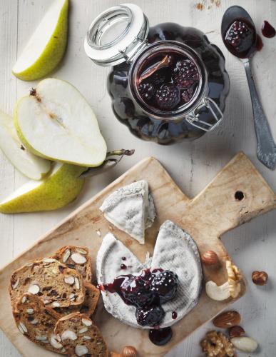 a cutting board with bread and a jar of jam at Intercontinental Shenzhen Dameisha Resort by IHG in Shenzhen
