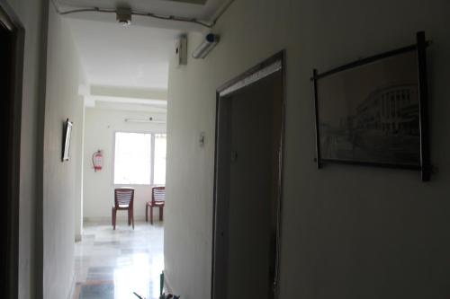 a hallway with a door leading to a dining room at Georgian Inn in Kolkata