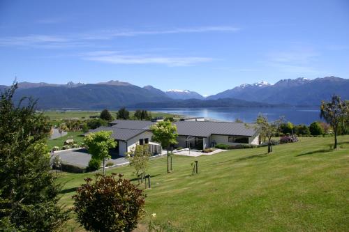 a house with a view of a lake and mountains at High Leys Lodge in Te Anau