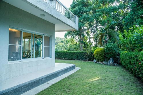 a house with a window and a yard at Mountain Homestay 6-8人包棟民宿 in Xinhua